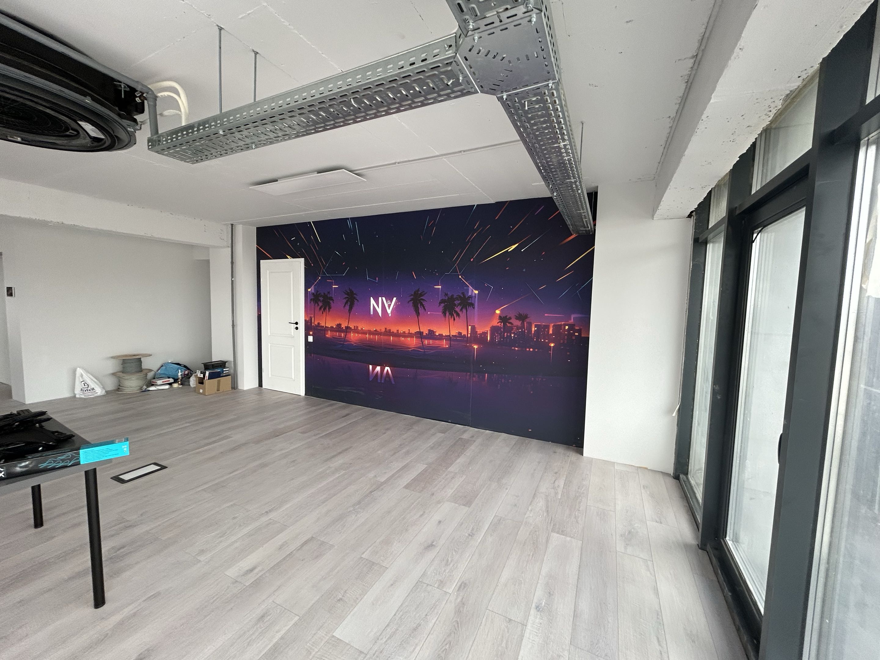 Brand new empty office space with NV synthwave wall mural, unfurnished